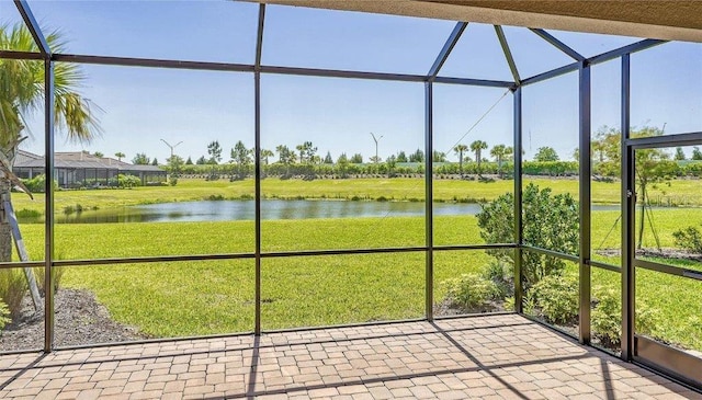 unfurnished sunroom with a water view