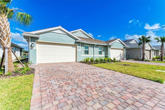 single story home with a garage and a front lawn