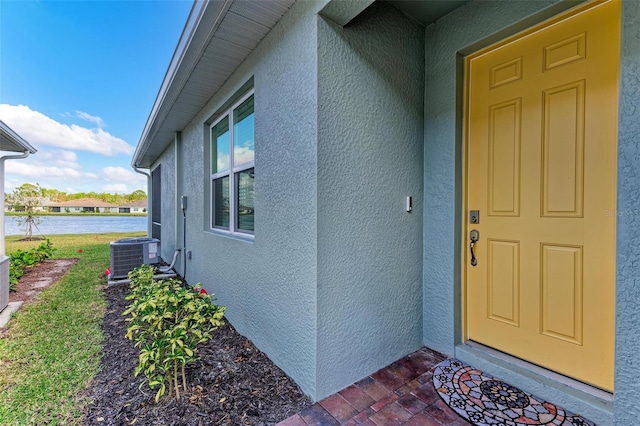 doorway to property featuring central air condition unit