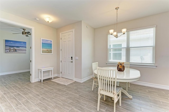 dining room featuring light wood-type flooring and ceiling fan with notable chandelier