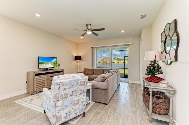 living room with ceiling fan and light hardwood / wood-style flooring