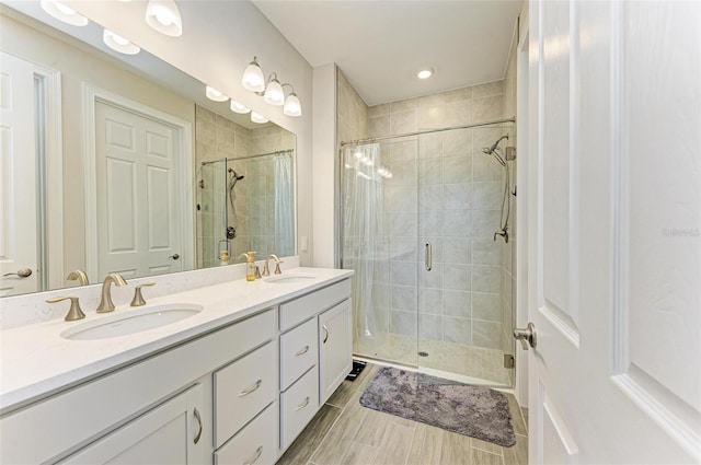 bathroom featuring vanity and a shower with door