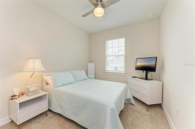 bedroom with ceiling fan and light carpet