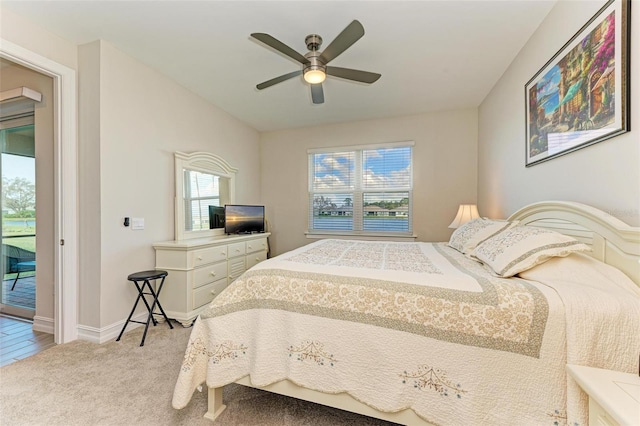 carpeted bedroom featuring ceiling fan and access to outside