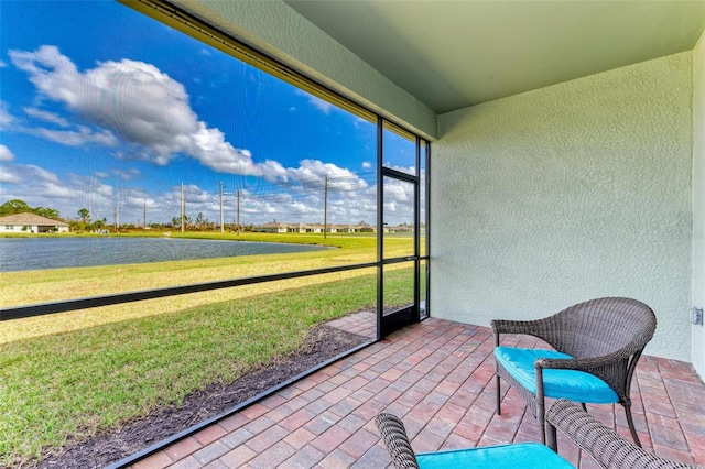 unfurnished sunroom with a water view