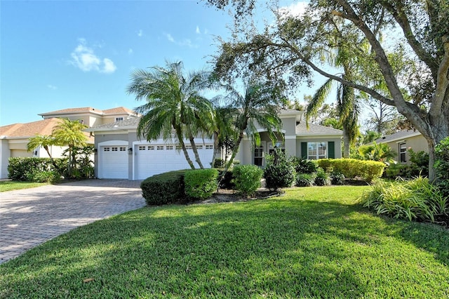 view of front of home with a front yard and a garage