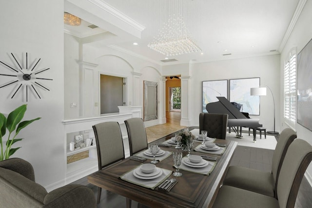 tiled dining room with ornate columns, a wealth of natural light, crown molding, and a notable chandelier