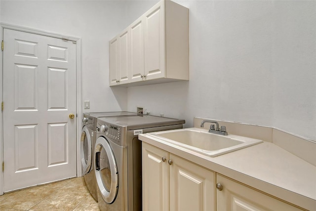 washroom with cabinets, separate washer and dryer, sink, and light tile patterned floors