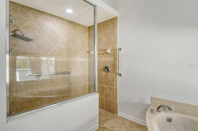 bathroom with shower with separate bathtub and tile patterned floors