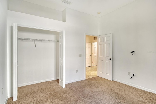 unfurnished bedroom with a closet and carpet floors