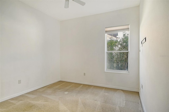 carpeted spare room with ceiling fan