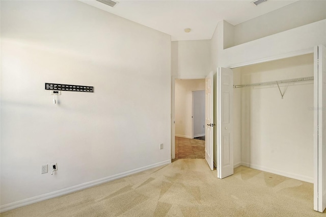 unfurnished bedroom featuring carpet and a closet