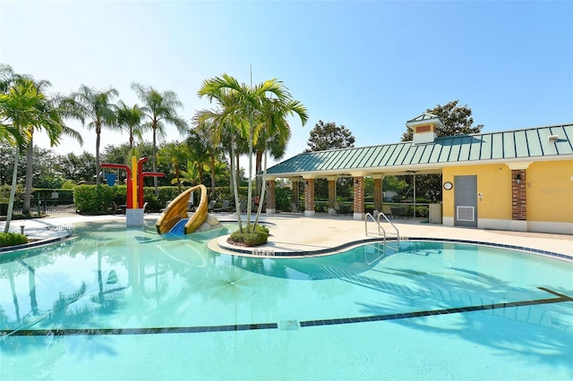 view of swimming pool featuring a patio area and a water slide