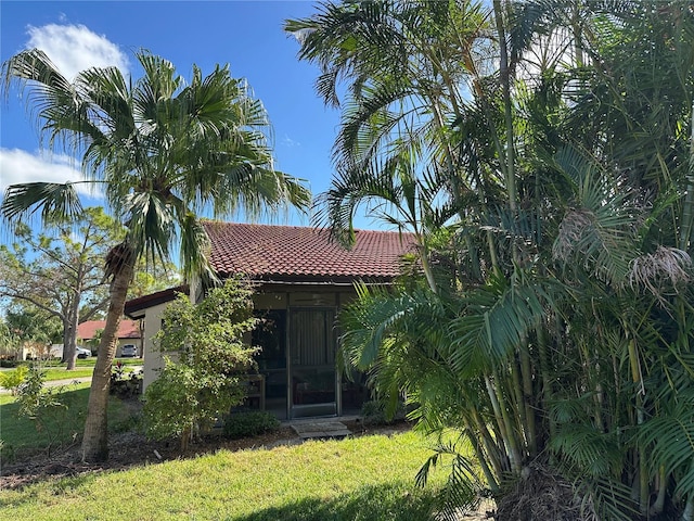 rear view of property featuring a lawn