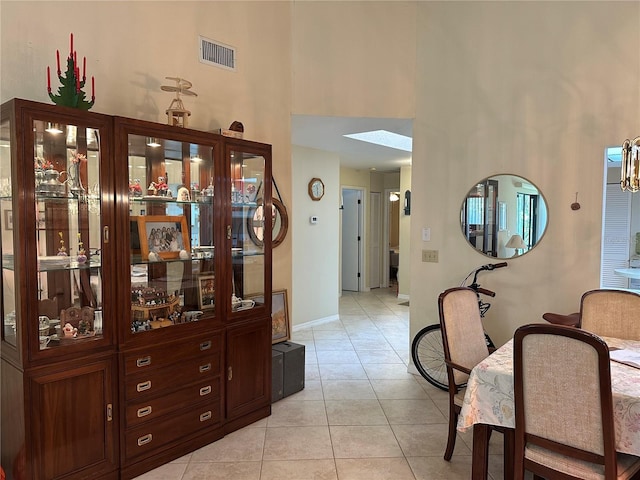 3711 Pinecone Ct Unit 168, Sarasota, FL 34238 - corridor with a towering ceiling, light tile patterned floors, baseboards, and a skylight