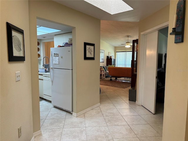3711 Pinecone Ct Unit 168, Sarasota, FL 34238 - hall with a skylight, light tile patterned floors, and a sink