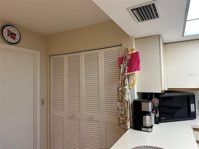 3711 Pinecone Ct Unit 168, Sarasota, FL 34238 - kitchen featuring black microwave and light countertops