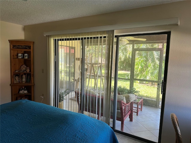 bedroom with access to exterior and a textured ceiling