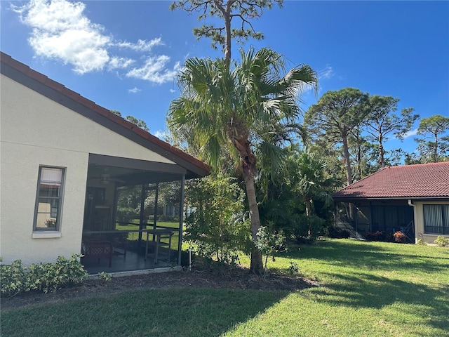 3711 Pinecone Ct Unit 168, Sarasota, FL 34238 - view of green lawn with a sunroom, ceiling fan, and a patio