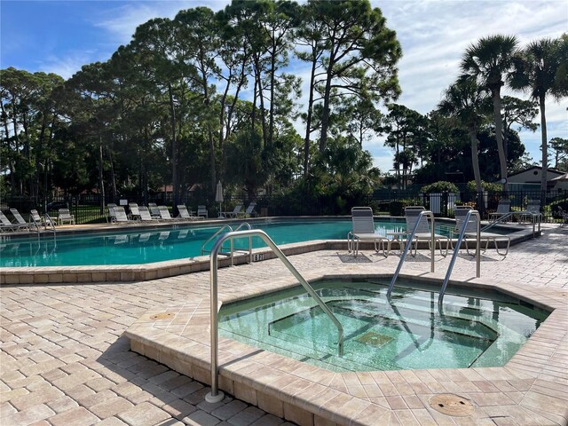 3711 Pinecone Ct Unit 168, Sarasota, FL 34238 - view of pool with a community hot tub, fence, a patio, and view of wooded area