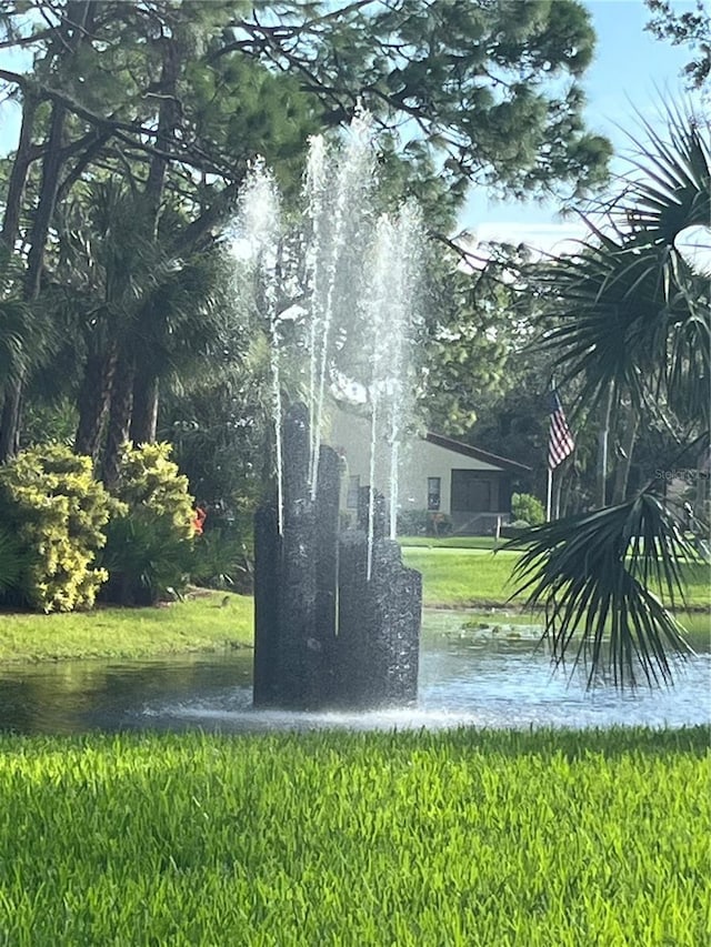 surrounding community featuring a water view and a yard