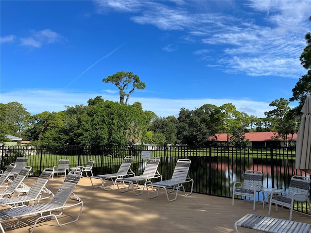 view of patio / terrace with a deck with water view