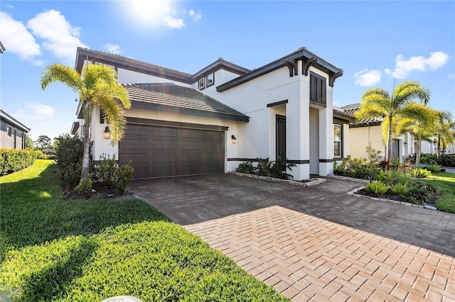 view of front of house with a garage and a front yard