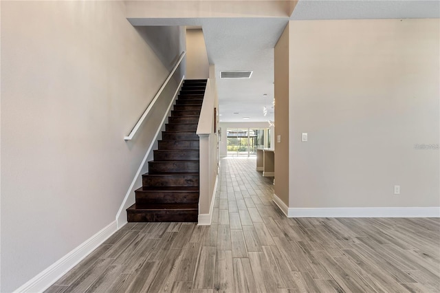 stairway featuring hardwood / wood-style flooring