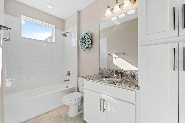 full bathroom featuring tile patterned floors, vanity, tiled shower / bath combo, and toilet