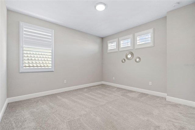 spare room with light colored carpet