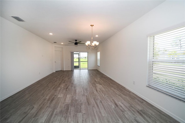 unfurnished room featuring dark wood-type flooring and ceiling fan with notable chandelier