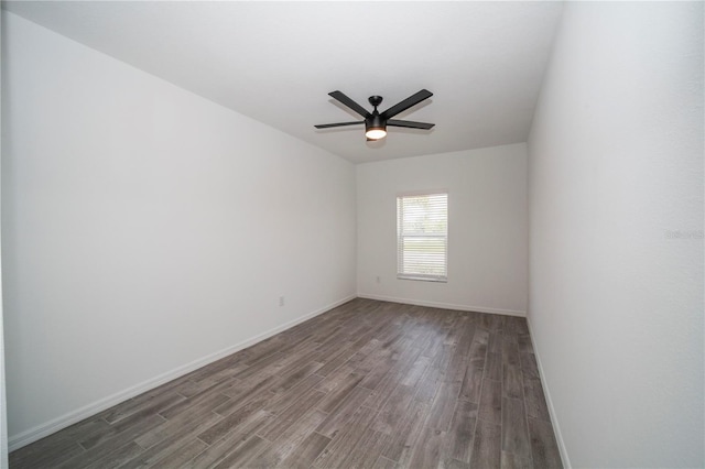 empty room with dark hardwood / wood-style flooring and ceiling fan