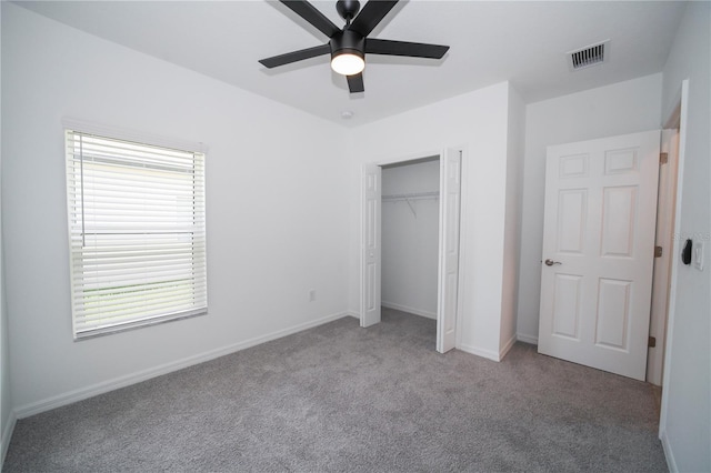 unfurnished bedroom featuring light colored carpet, ceiling fan, and a closet