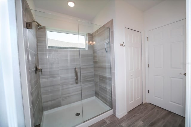 bathroom featuring wood-type flooring and an enclosed shower