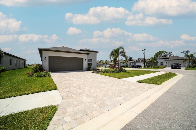 view of front of house featuring a garage and a front yard