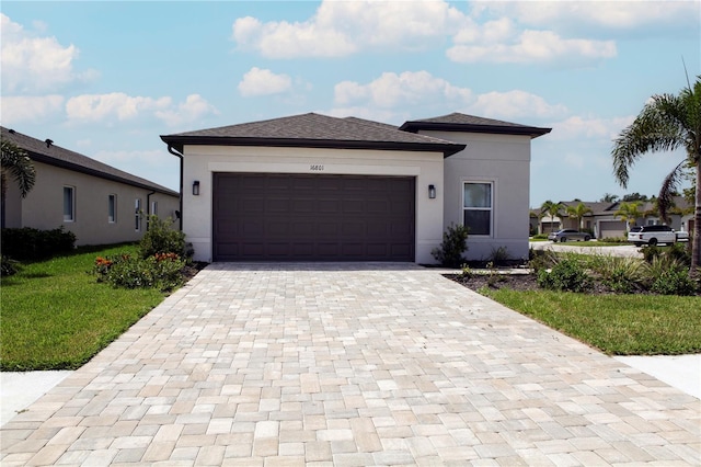 view of front of house with a garage and a front lawn