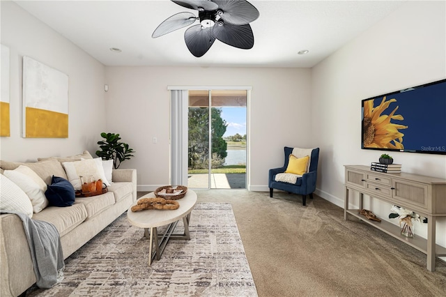 carpeted living room featuring ceiling fan