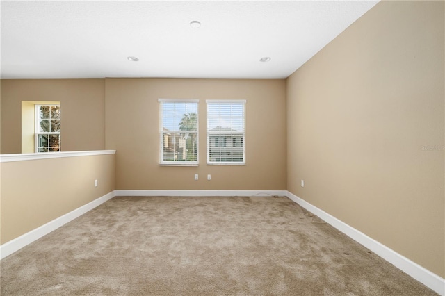 unfurnished room with light carpet