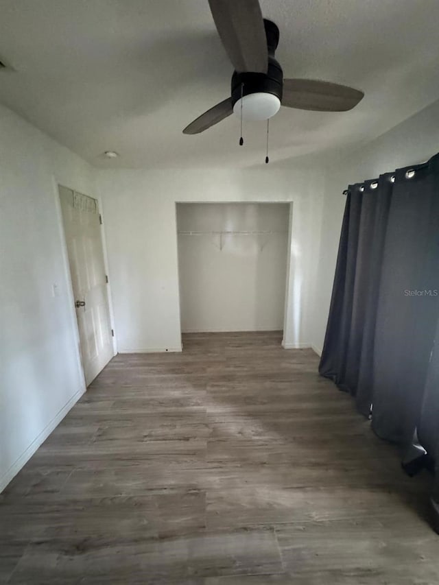 empty room featuring hardwood / wood-style floors and ceiling fan