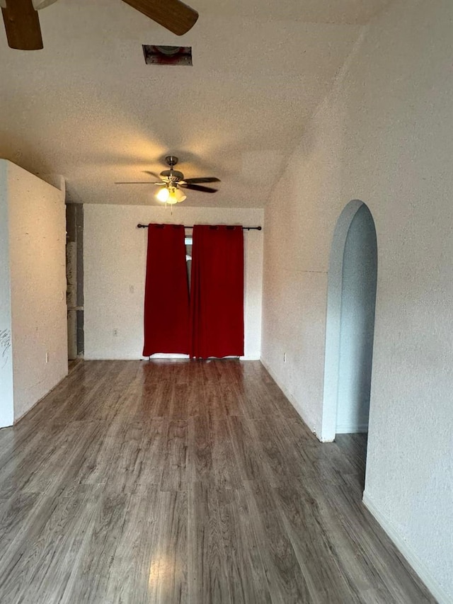 empty room featuring hardwood / wood-style flooring, ceiling fan, and a textured ceiling