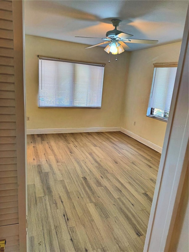 spare room featuring ceiling fan and light hardwood / wood-style floors