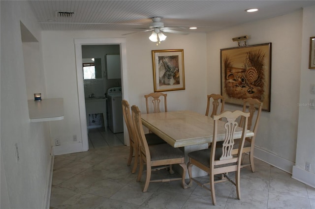 dining area featuring ceiling fan and washer / dryer