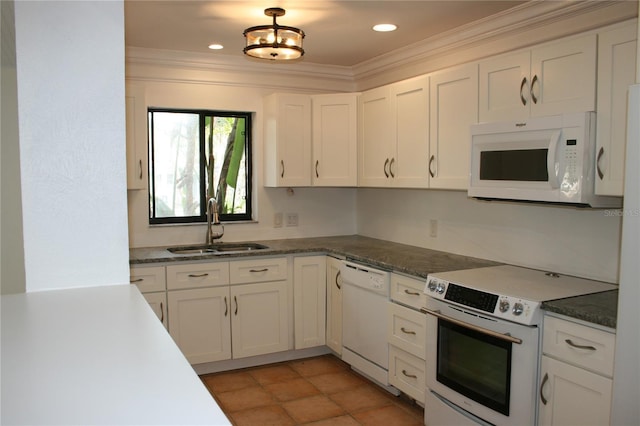 kitchen with crown molding, sink, white appliances, and white cabinetry