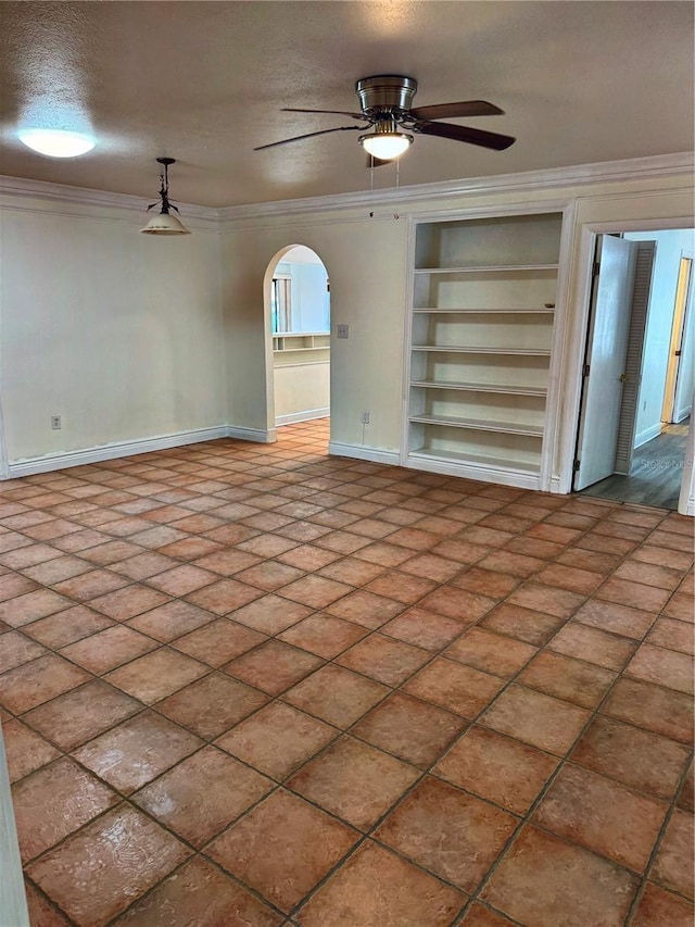 unfurnished living room with ceiling fan, built in features, a textured ceiling, and ornamental molding