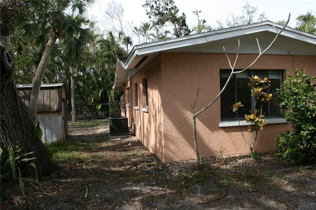 view of side of property featuring central AC unit