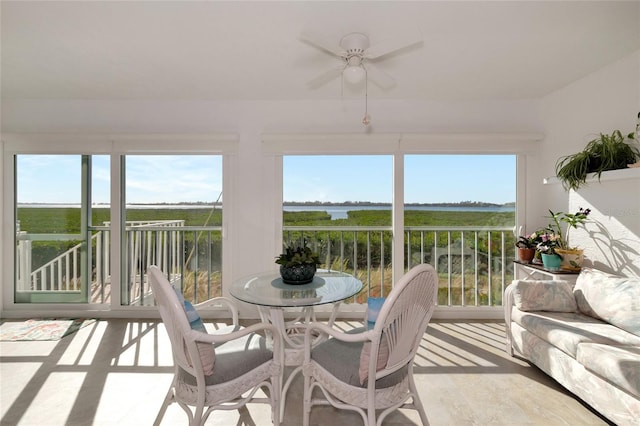 sunroom / solarium featuring ceiling fan