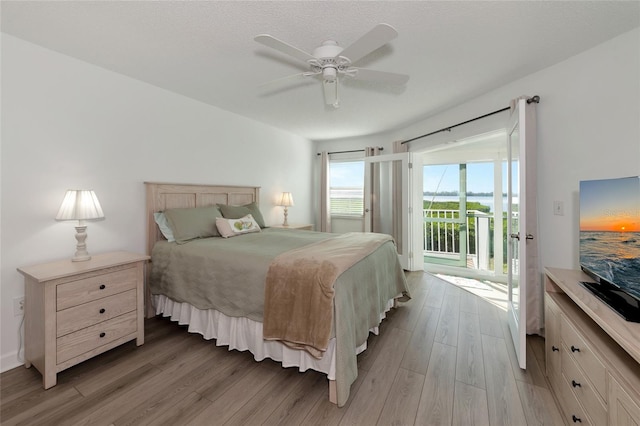 bedroom featuring access to outside, ceiling fan, and light hardwood / wood-style flooring