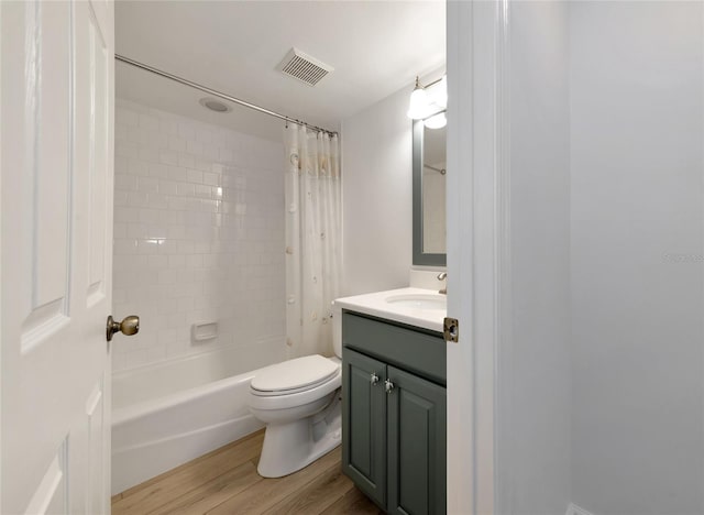 full bathroom featuring toilet, shower / tub combo, vanity, and wood-type flooring