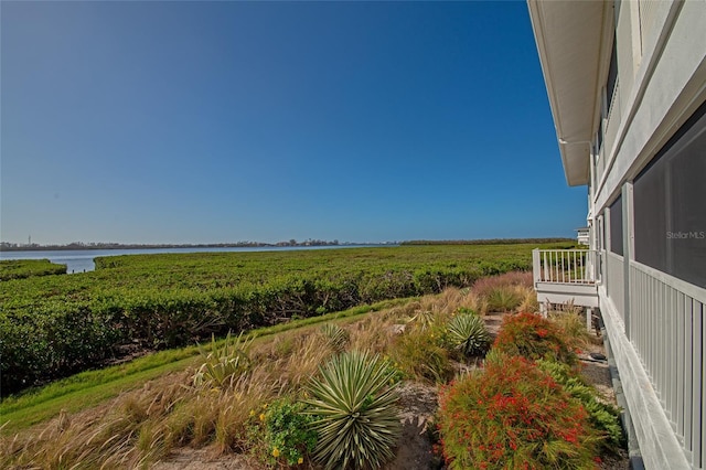 view of yard featuring a water view and a rural view