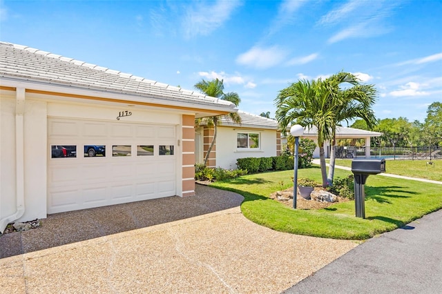 ranch-style home featuring a front lawn and a garage